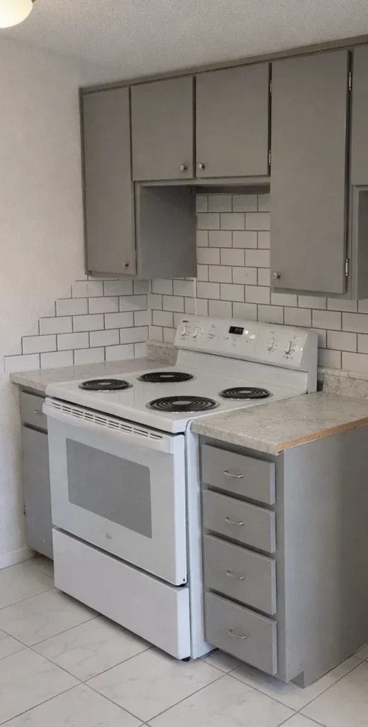 Updated Kitchen Appliances at La Villa Elms White electric stove and oven surrounded by grey cabinetry in utilities included apartments El Reno.